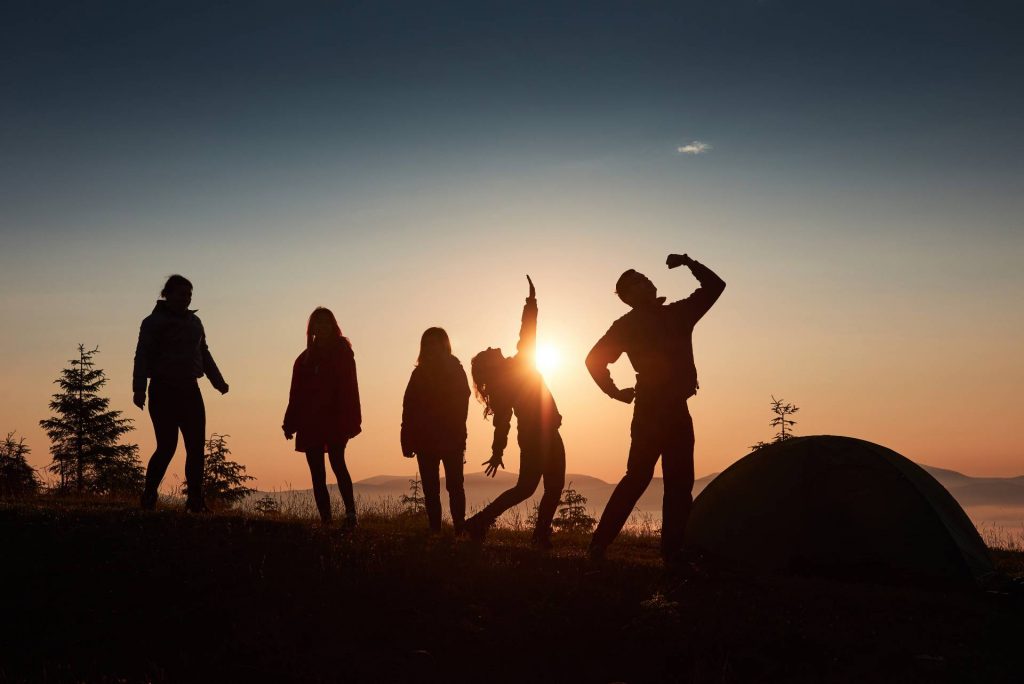 A work team climbing a mountain as part of their corporate team building activities